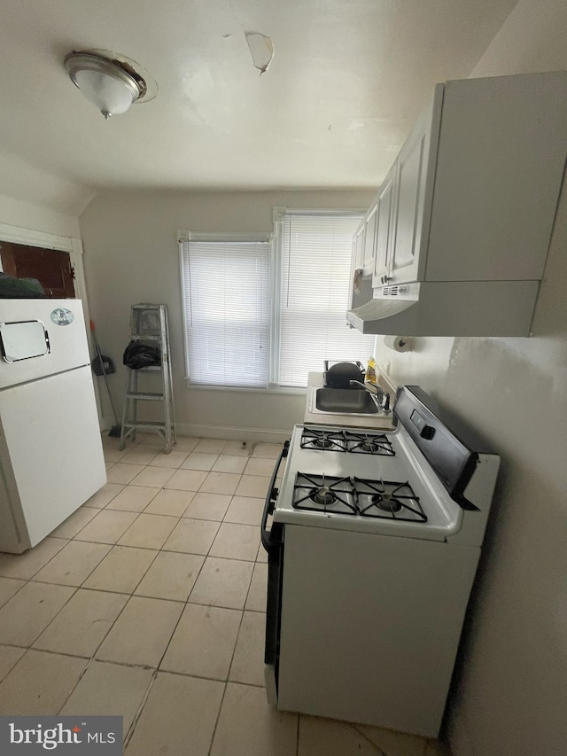 kitchen featuring light tile patterned flooring, white appliances, sink, and white cabinets