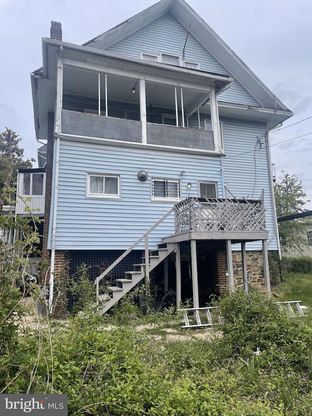 rear view of house featuring a balcony