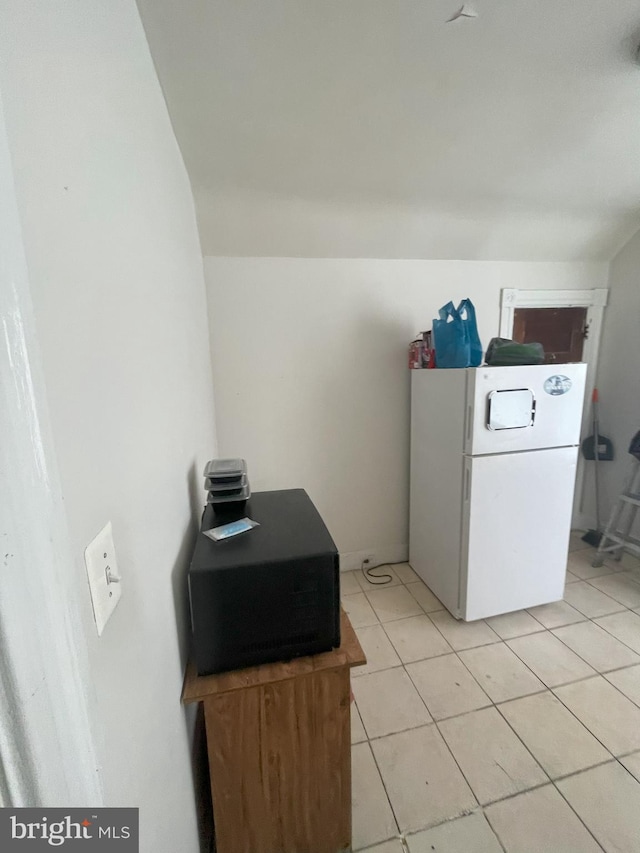 clothes washing area featuring light tile patterned floors