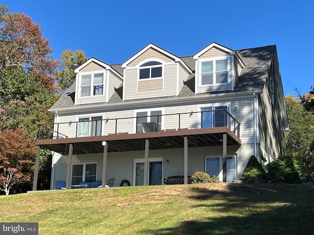 back of property featuring a garage and a lawn