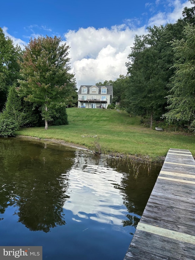 dock area featuring a lawn and a water view