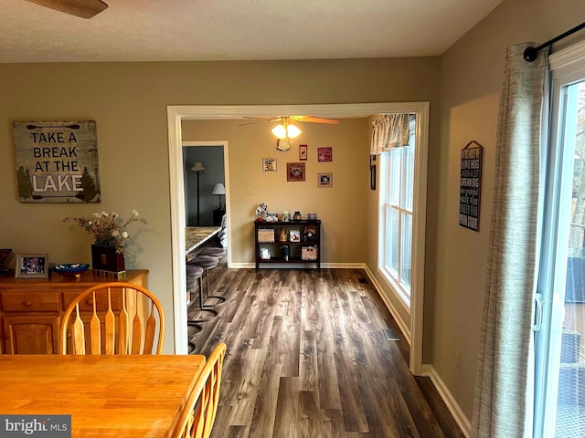 dining area featuring ceiling fan and dark hardwood / wood-style flooring