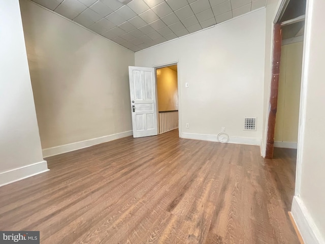 spare room with wood-type flooring