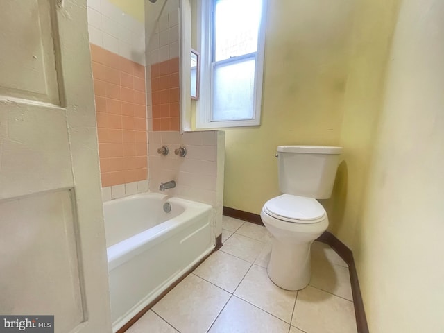 bathroom with tile patterned floors, toilet, and tiled shower / bath combo