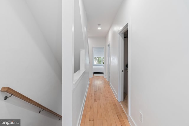 corridor with light hardwood / wood-style floors