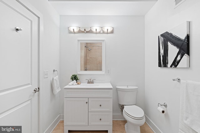 bathroom featuring vanity, tile patterned floors, and toilet