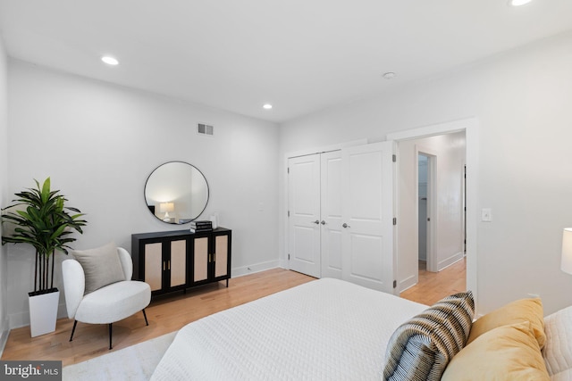 bedroom featuring light hardwood / wood-style flooring and a closet