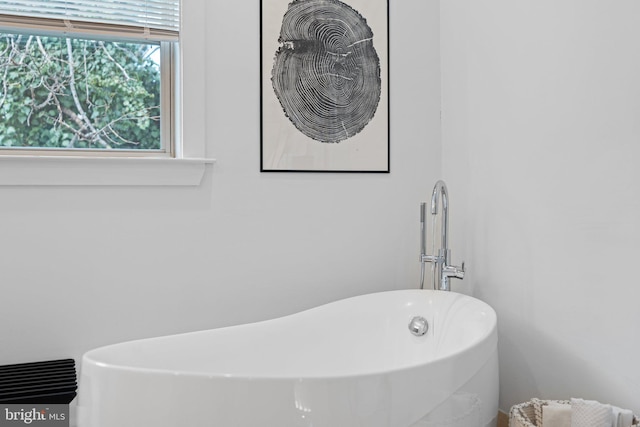 bathroom featuring a tub to relax in