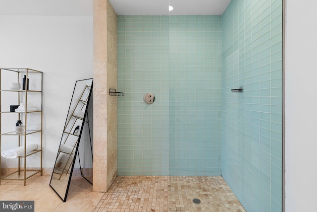 bathroom with tile patterned flooring and a tile shower