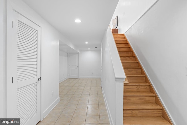 stairway featuring tile patterned flooring