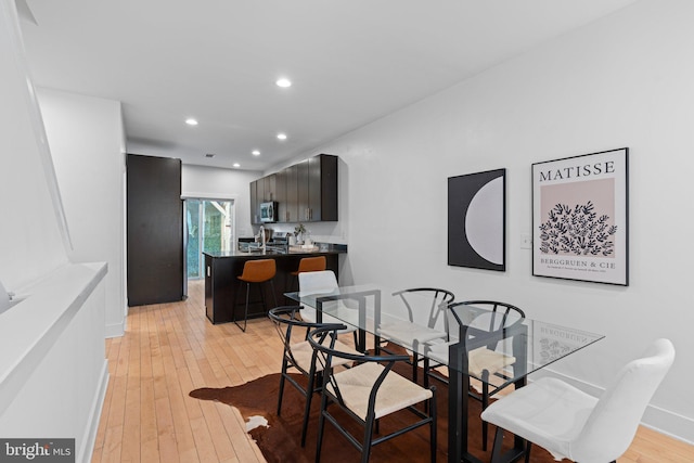 dining space with light hardwood / wood-style floors