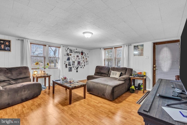 living room featuring a textured ceiling, hardwood / wood-style floors, and a wealth of natural light