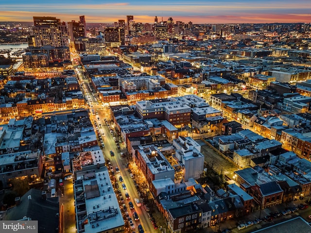 aerial view at dusk featuring a city view