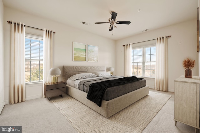 bedroom featuring carpet, visible vents, and multiple windows