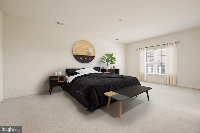 bedroom featuring carpet floors, visible vents, and baseboards