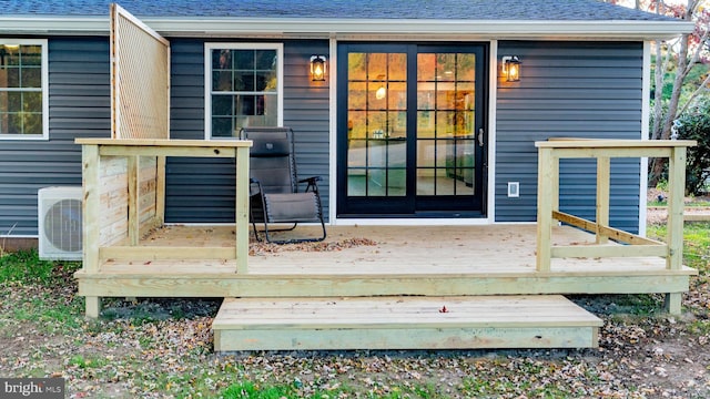 wooden deck featuring ac unit