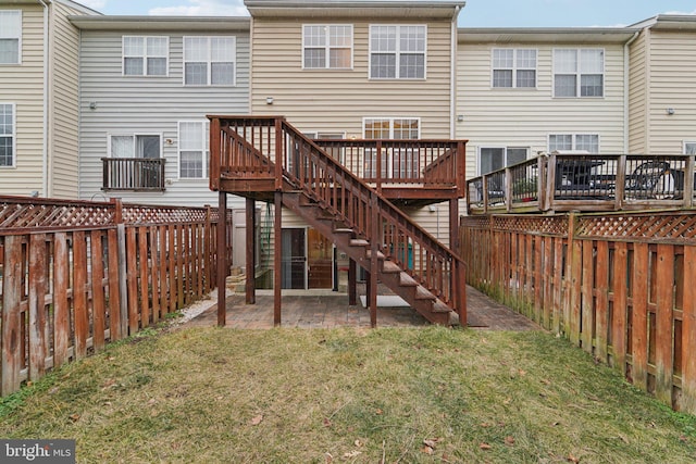 rear view of house featuring a yard, a deck, and a patio area