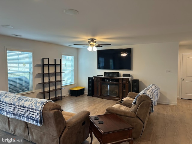 living room with hardwood / wood-style flooring and ceiling fan