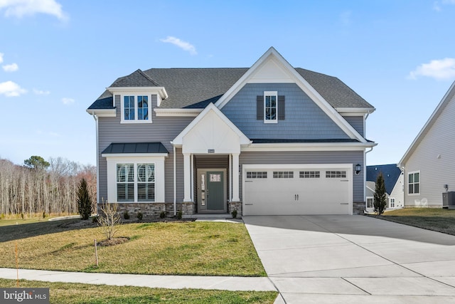 craftsman-style house featuring stone siding, an attached garage, central AC, a front yard, and driveway