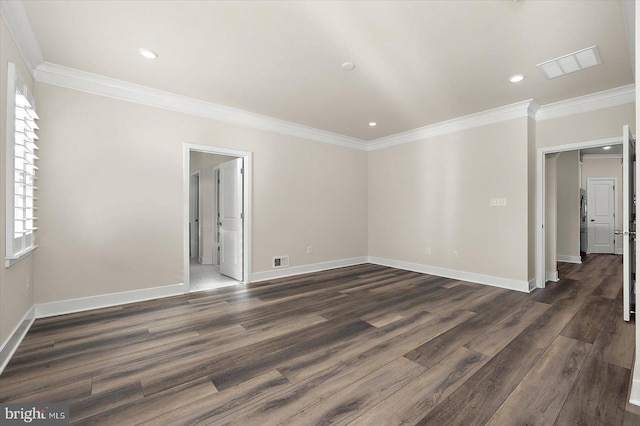 spare room featuring visible vents, crown molding, and dark wood-style flooring