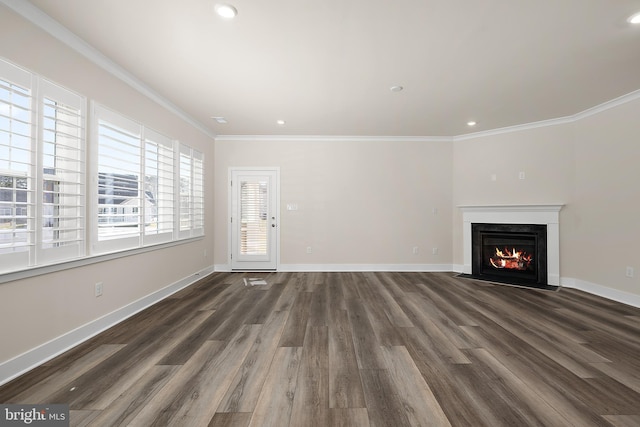 unfurnished living room with a fireplace with flush hearth, baseboards, and ornamental molding