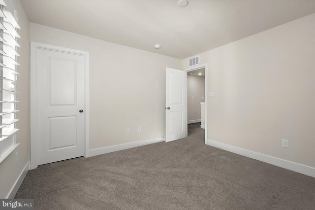 unfurnished bedroom with baseboards, visible vents, and carpet floors