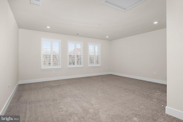spare room with visible vents, carpet, baseboards, and recessed lighting