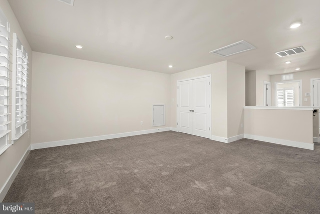 carpeted empty room with baseboards, visible vents, and recessed lighting