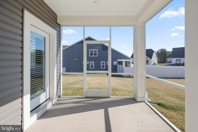 unfurnished sunroom featuring a residential view
