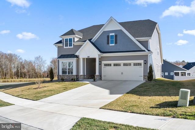 view of front of house featuring a front yard, stone siding, and concrete driveway