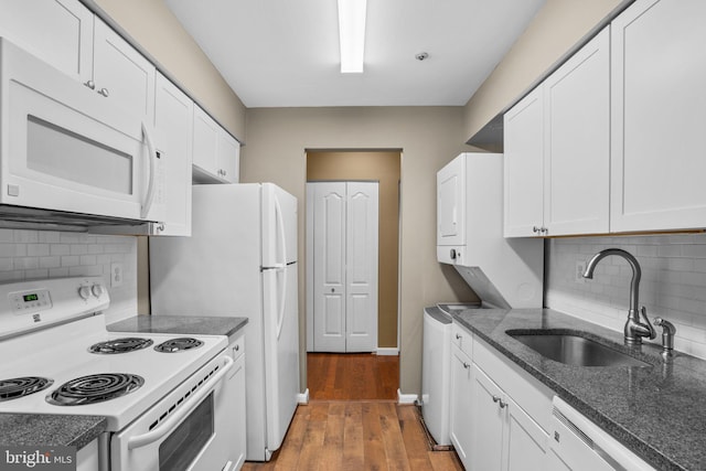 kitchen featuring dark wood finished floors, white appliances, white cabinets, and a sink