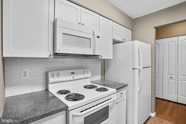 kitchen with white appliances, tasteful backsplash, and white cabinetry