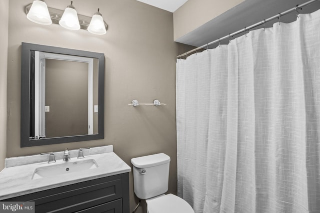 full bathroom with toilet and vanity