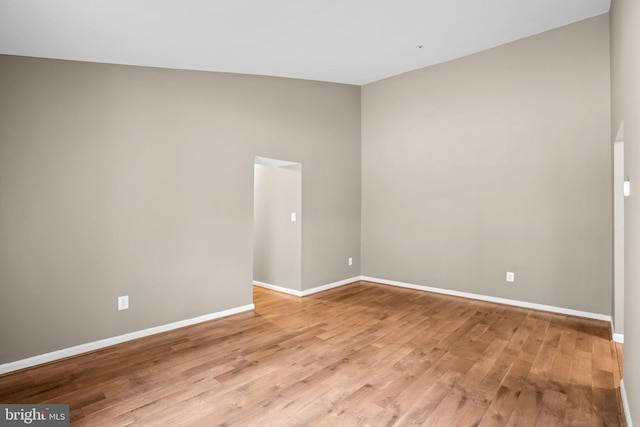 unfurnished room featuring light wood-style flooring and baseboards