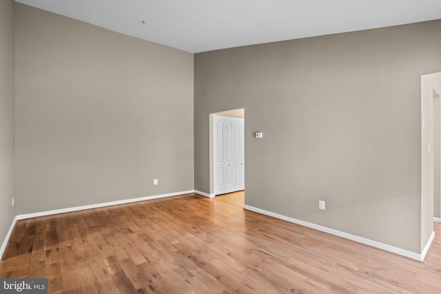 unfurnished room featuring light wood-type flooring and baseboards