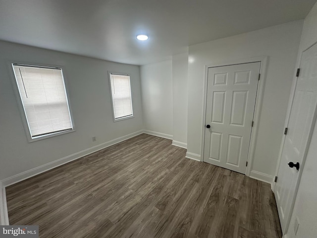 empty room with dark wood-type flooring