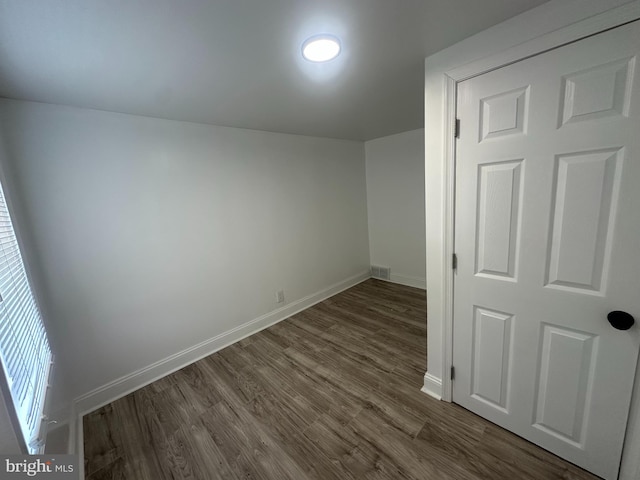 additional living space featuring dark hardwood / wood-style flooring