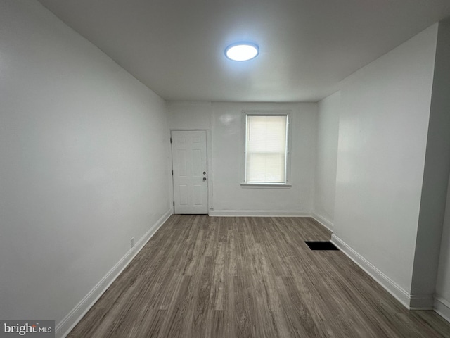 unfurnished room featuring dark hardwood / wood-style floors