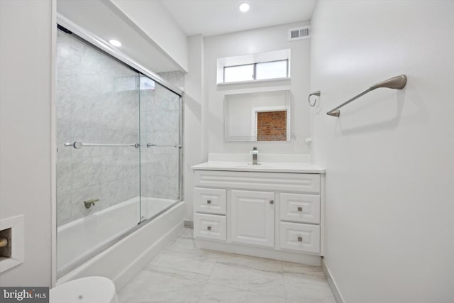 full bathroom with vanity, enclosed tub / shower combo, and toilet