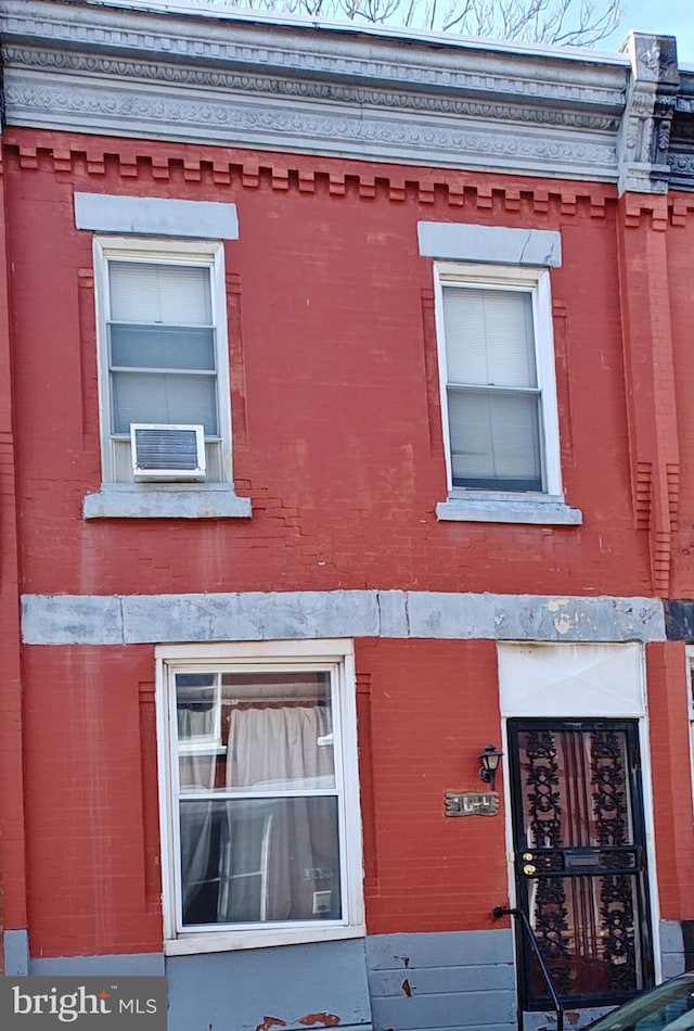 view of side of home with brick siding