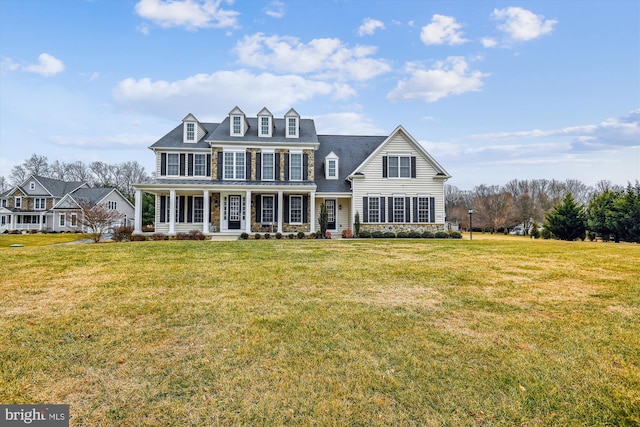 view of front of home with a front yard and a porch