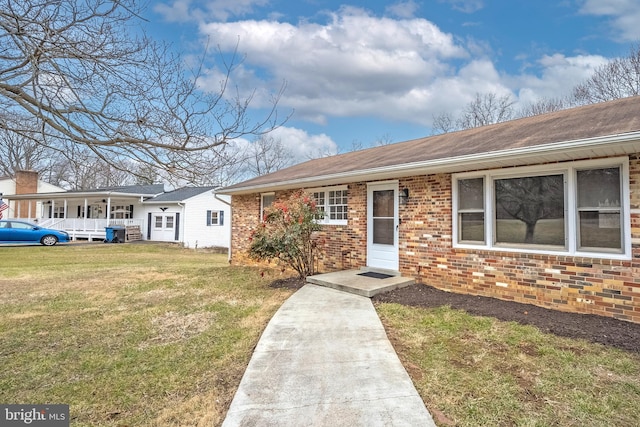 ranch-style home featuring a front yard