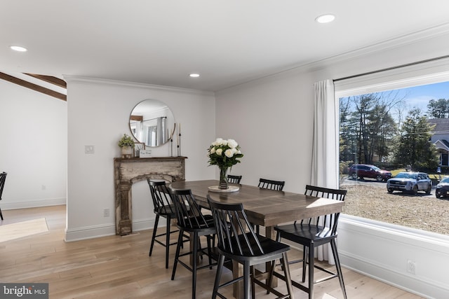 dining room with light hardwood / wood-style flooring and ornamental molding