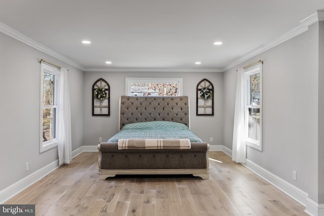 bedroom with crown molding and light hardwood / wood-style flooring