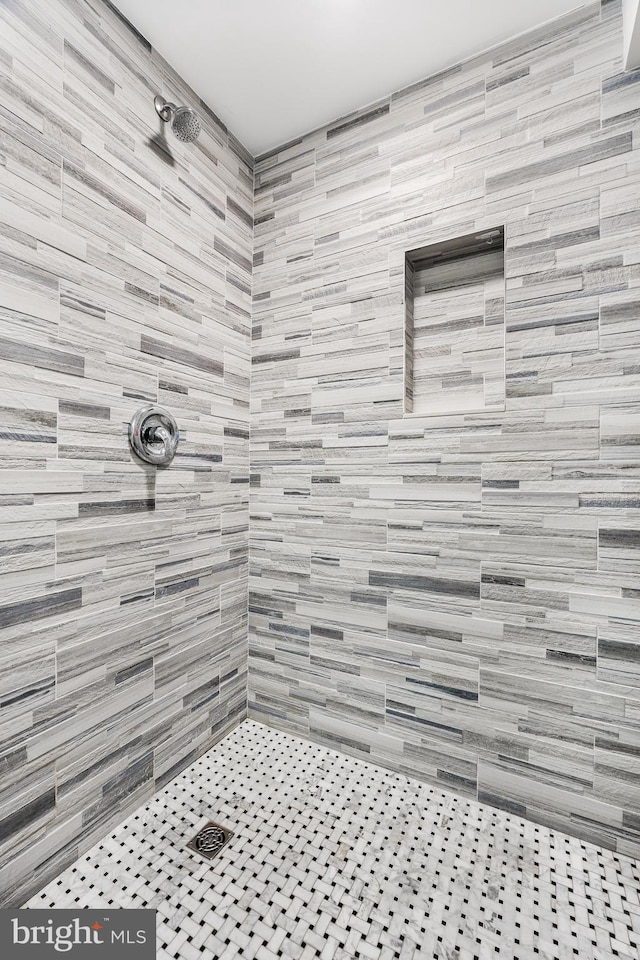 bathroom with tiled shower