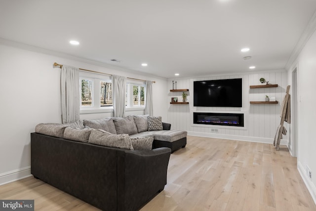 living room with ornamental molding and light wood-type flooring