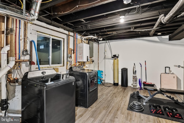 basement with water heater and light hardwood / wood-style flooring