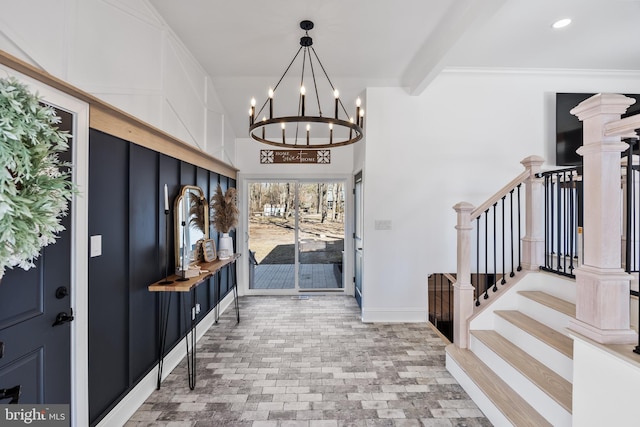 entrance foyer featuring an inviting chandelier and beam ceiling