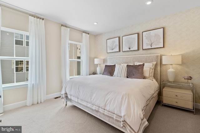 bedroom featuring light carpet