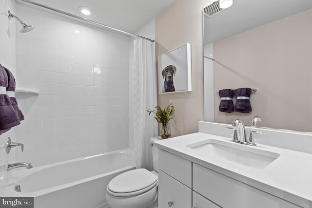 full bathroom with vanity, shower / bath combination with curtain, and toilet